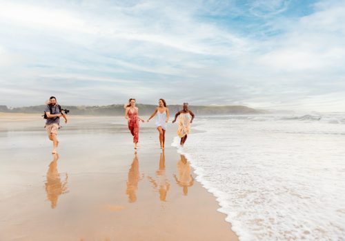 filmmaker working with models on the beach
